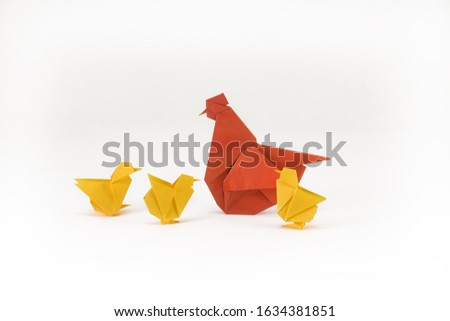Origami rooster and chicken on a white background