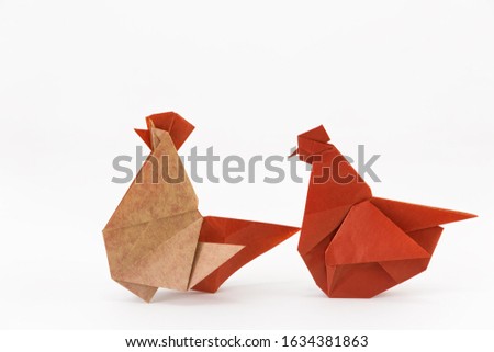 Origami rooster and chicken on a white background