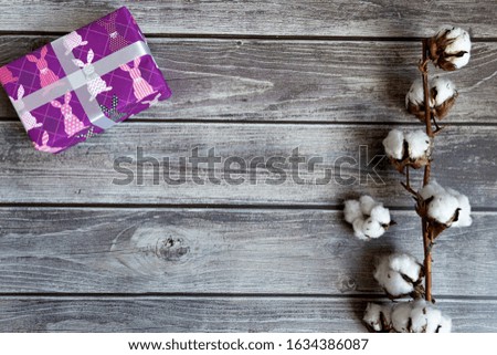 
Cotton flower and easter gift on wooden background