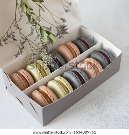 A half-closed box of pastel-colored macaroons.