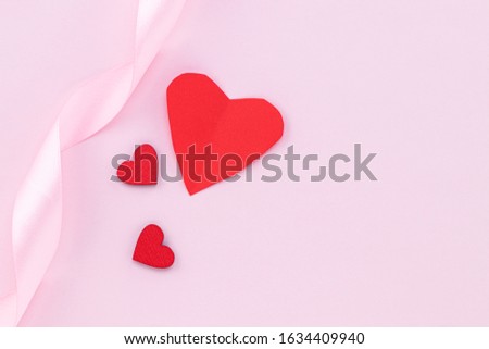 Valentines Day background. Red hearts on pastel pink background. Valentines day concept. Flat lay, top view, copy space.
