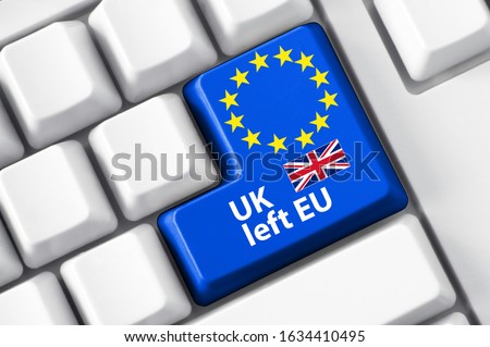 White keyboard and blue button with European Union and England flag aside. UK has left EU concept