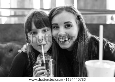 Young girl with a girl in a cafe
