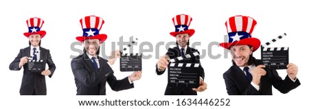 Man with USA hat and movie board isolated on white