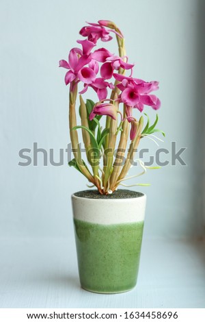 Bouquet of fake purple orchids in a vase