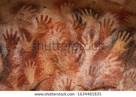 Prehistoric hand paintings at the Cave of Hands (Spanish: Cueva de Las Manos) in Santa Cruz Province, Patagonia, Argentina. The art in the cave dates from 13,000 to 9,000 years ago. Royalty-Free Stock Photo #1634481835