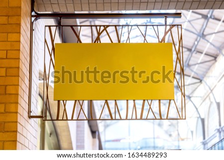 Yellow company sign mockup on a brick wall.