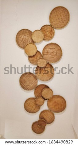 Woven bamboo handicrafts of household appliances, become ornaments that are affixed to the walls of the house