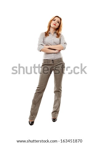 Full length portrait of young confident businesswoman with arms folded, isolated on white background