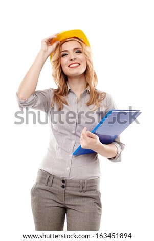 Young successful woman engineer wearing protection helmet and holding a construction plan, isolated on white background