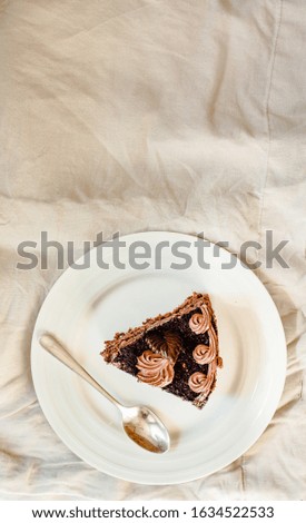 Dark Chocolate Cake with Chocolate Glaze for Holiday and cup of coffee. White linen tablecloth background. Top view. Free space for text.Valentine's day or March 8, Happy Women's Day concept.