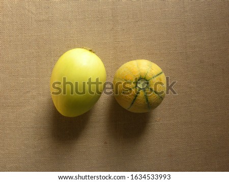 Yellow whole ripe Sun melon and Striped Muskmelon