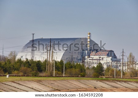 Reactor 4 at the Chernobyl nuclear power plant with a new confinement. Global atomic disaster. Chernobyl Exclusion Zone. Pripyat in the area of the sarcophagus over a blasted nuclear reactor Royalty-Free Stock Photo #1634592208