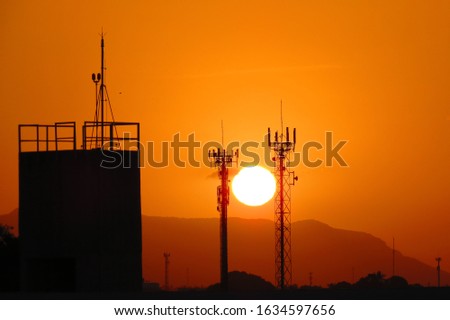 sunset between towers and mountains.