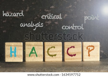  HACCP stamped on a wood scrabble pieces over a grunge black background