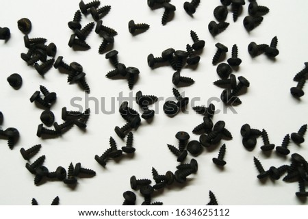 steel screws are scattered on a white background