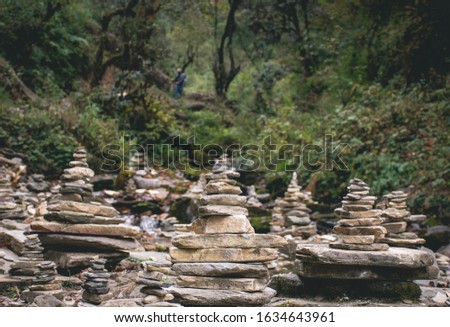 Group of cairns (small piles of stones) found in the forest of the Annapurna Base Camp trek in Nepal.
