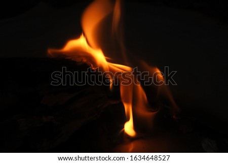 a large flame burns paper