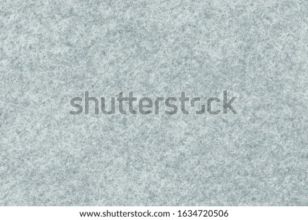 Close-up soft grey felt material. Surface of felted fabric texture abstract background in gray color.