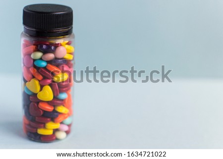 Multi-colored sweets in packaging, jar. Romantic sweets in the shape of hearts.