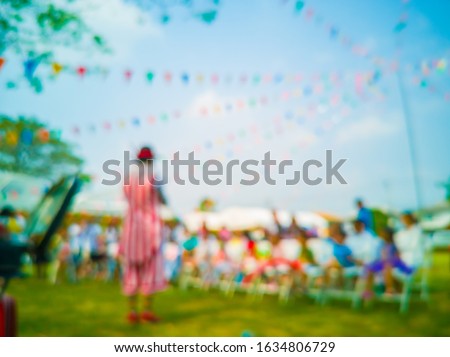 Blurred images of Funny magician,joker and Colorful flags, colorful party decorations, small triangular flags to celebrate the party with the blue sky and clouds as the holiday concept background.