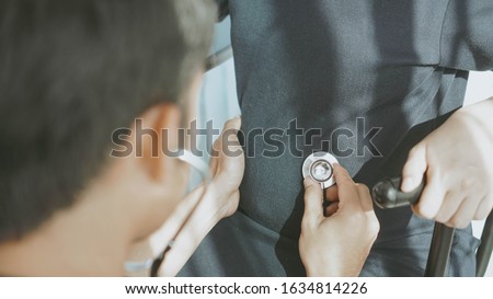 doctor uses a stethoscope to check the pregnancy.Happy young pregnant attractive woman, Sitting and look at the ultrasound pictures, touching her belly ,pregnancy expectation concept