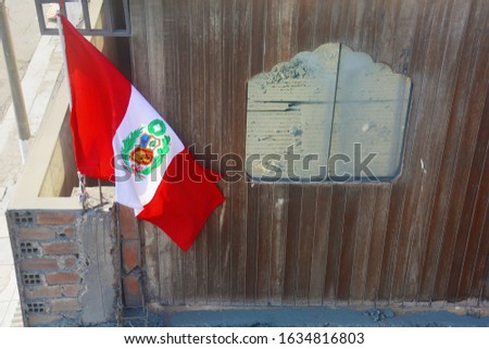 Peruvian flag on poor house. Independence day.