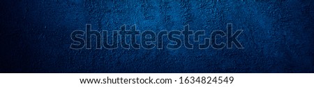   Dark blue grunge banner. Rough grainy concrete wall surface texture. Close-up. Abstract blue concrete background. Detail. Copy space for your design.                             