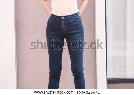 Happy Asia woman in denim skinny jeans, midnight blue jeans