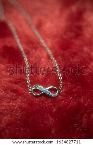 love gift with infinity. jewelry and anniversary concept Royalty-Free Stock Photo #1634827711