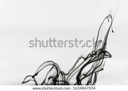 Abstract black and white background: ink effectively spread in the water. Copyspace.
