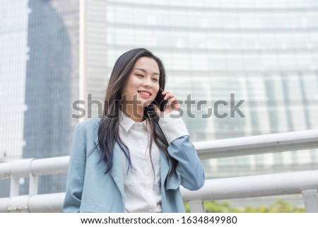 Young business women call in the business district Royalty-Free Stock Photo #1634849980