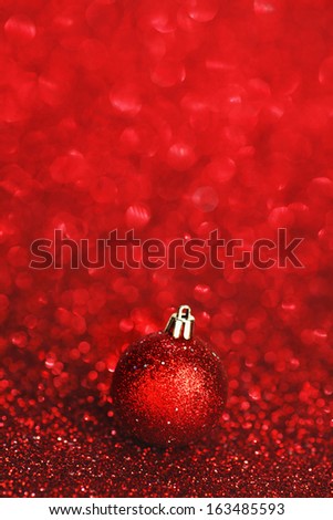 Christmas card with beautiful shiny decoration over red background