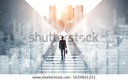 Ambitious business man climbing stairs to meet incoming challenge and business opportunity. The high stair represents the concept of career path success, future planning and business competitions. Royalty-Free Stock Photo #1634861251
