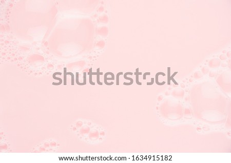 Pink bubbles and pink water with copy space as  festive abstract background for Valentine's day, wedding, spring.