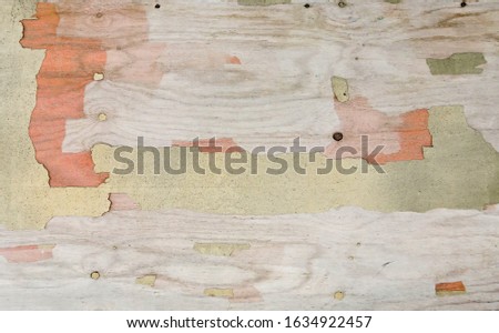 Old cracked plywood with a beautiful texture. Frame with an unusual background and free space for ad, advertisement, advertising.                              