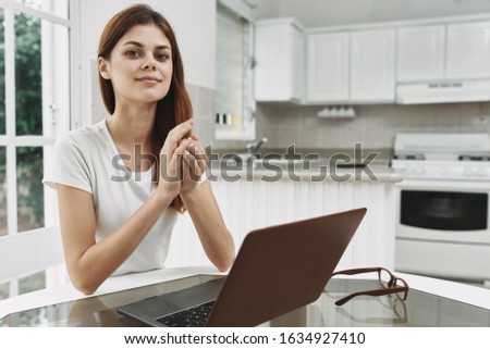 Laptop woman freelancer work at home kitchen interior