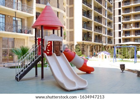 play ground red and white big plastic toy set for children school or city garden park . Children kids playground with play equipment outdoor. Kids playground with slides in the park.