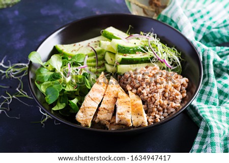 Lunch salad. Buddha bowl with buckwheat porridge, grilled chicken fillet, corn salad, microgreens and daikon. Healthy food.