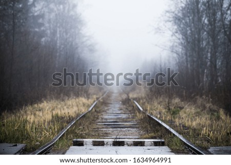 Empty railway perspective and striped wooden border sign, background photo