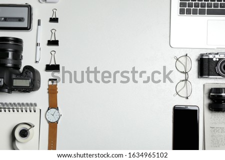 Flat lay composition with equipment for journalist on white table. Space for text