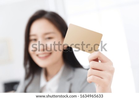 Business young woman with a card