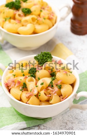 macaroni cheese with bacon on white backdrop 