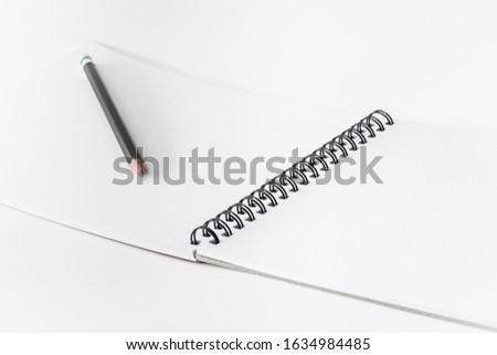 book and pencil Mockup of opened blank square ctalogue at white design paper background.