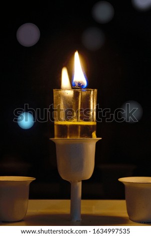 Hanukkah candle burning. 
Oil candle burning.  
