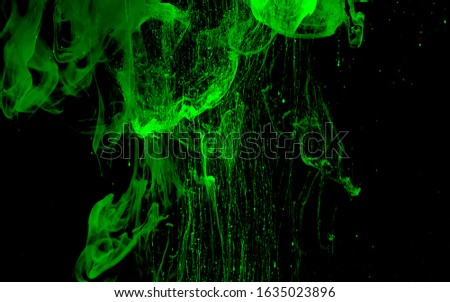 Green nano-digital abstract background. Colored space background. Green watercolor ink in water on a black background. Cool trending screensaver. Neural networks.