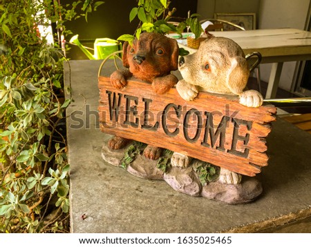 Dogs welcome signboard vintage style for home and restaurant. Concept of the vintage antique sign with cute puppy warm welcome for homecoming.