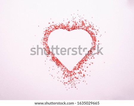 Colored sugar sprinkles heart, Sugar sprinkle dots and hearts, decoration for cake and bakery, heart shaped symbol of love on valentines day. Top view
