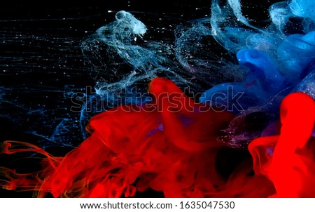 Stylish abstract modern background. White, blue and red watercolor ink in water. A powerful explosion of colors. Cool trending screensaver.