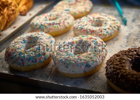 Multi colored donuts on the cafe counter 